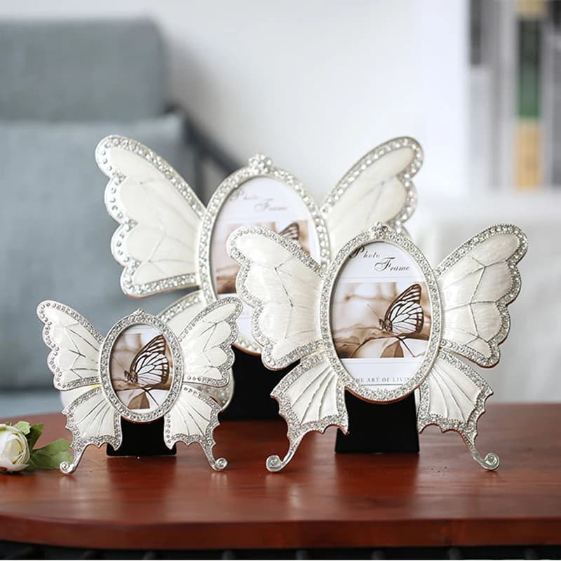 Frame for photo in metal alloy with shiny silver white butterfly with transparent rhinestones, blue amber zinc pieces for the decorated house