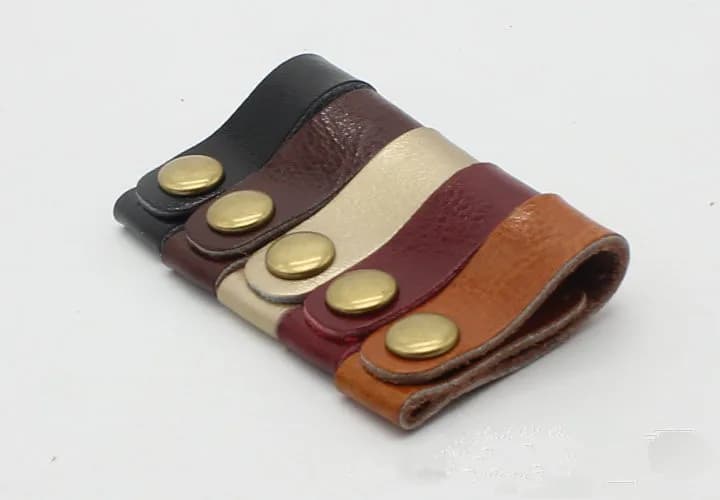 100 pz/lotto moda in vera pelle avvolgicavo per cuffie auricolare cavo organizzatore supporto per cavo per iphone samsung