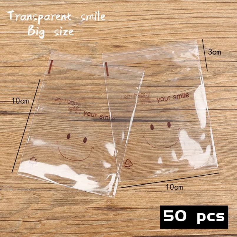 50 pz/lotto sacchetti di carta autoadesiva in Cellophane trasparente per biscotti con sorriso sacchetto di imballaggio per sapone adorabile confezione autoadesiva fatta in casa
