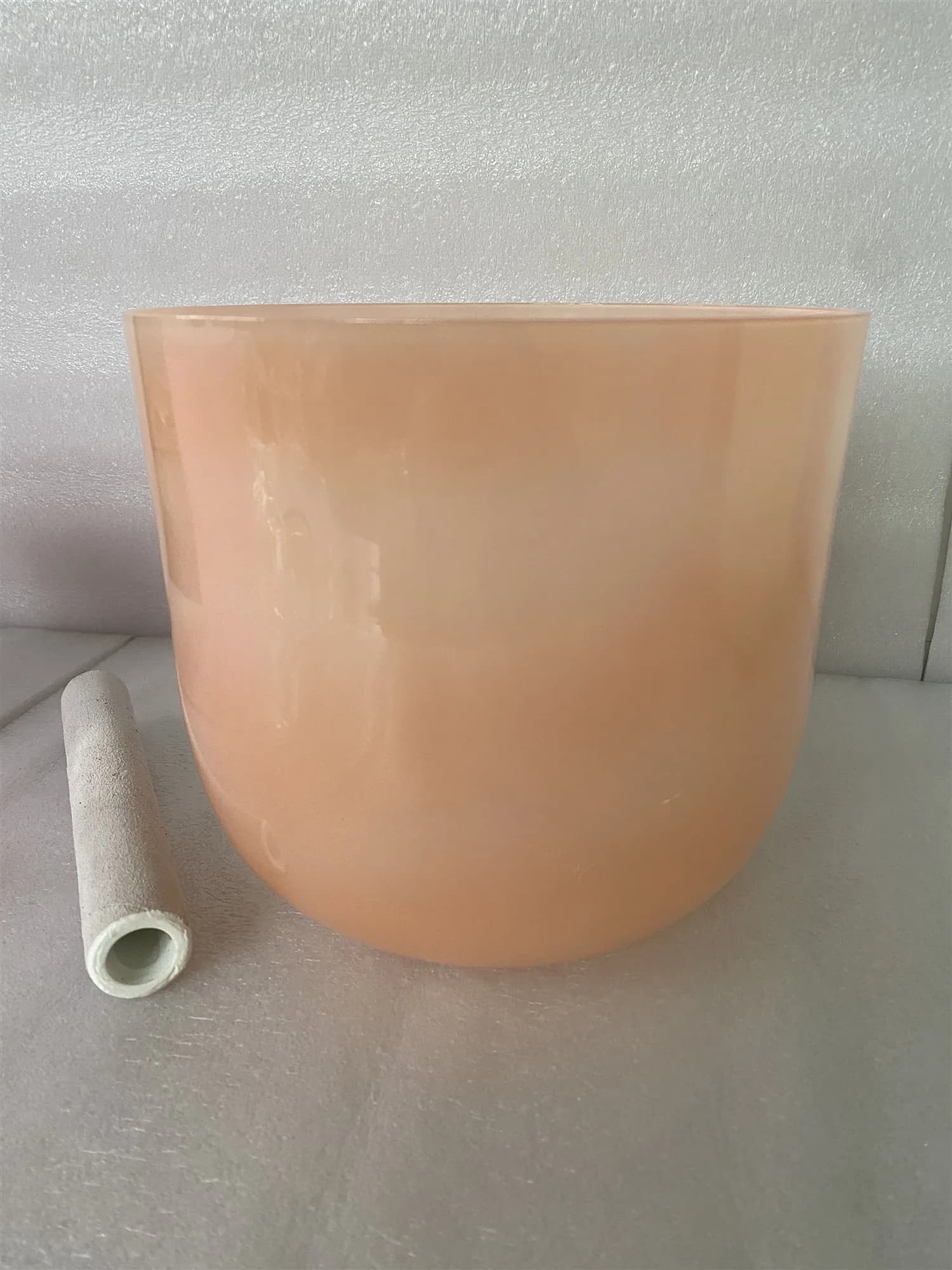Crystal singing bowl pastel orange color 432Hz 3rd octave D note Sacral chakra or D# note Adrenals chakra for sound healing.