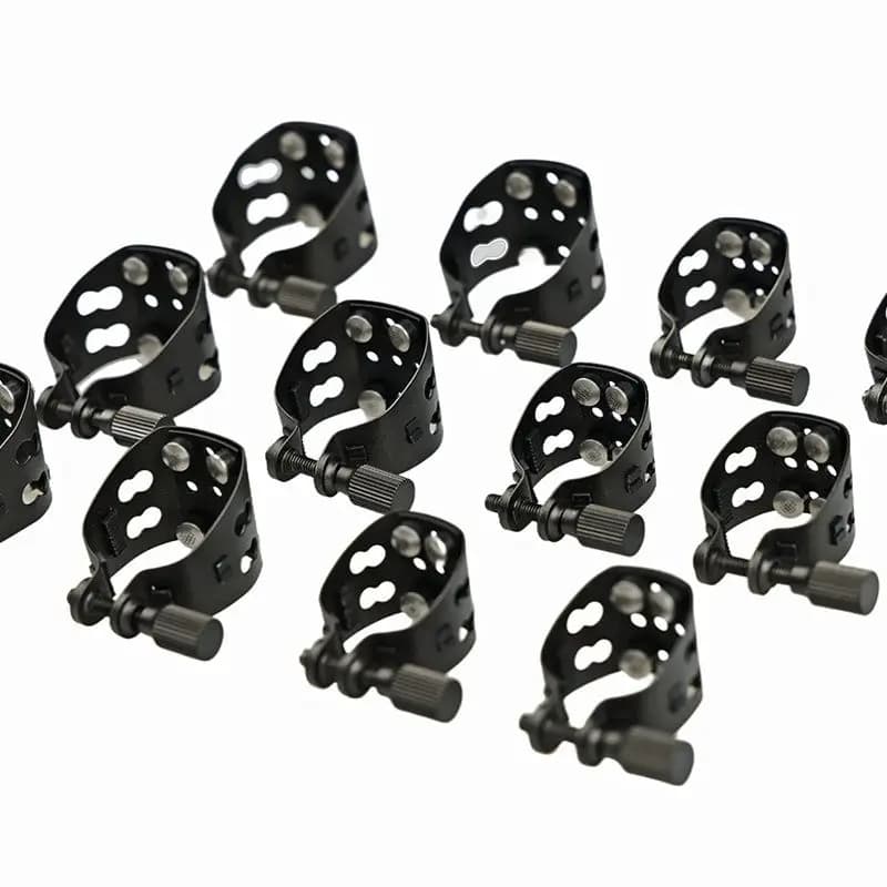 Black gold steel saxophone mouthpiece clip with six spaces and four elastomers designed to increase reed vibration