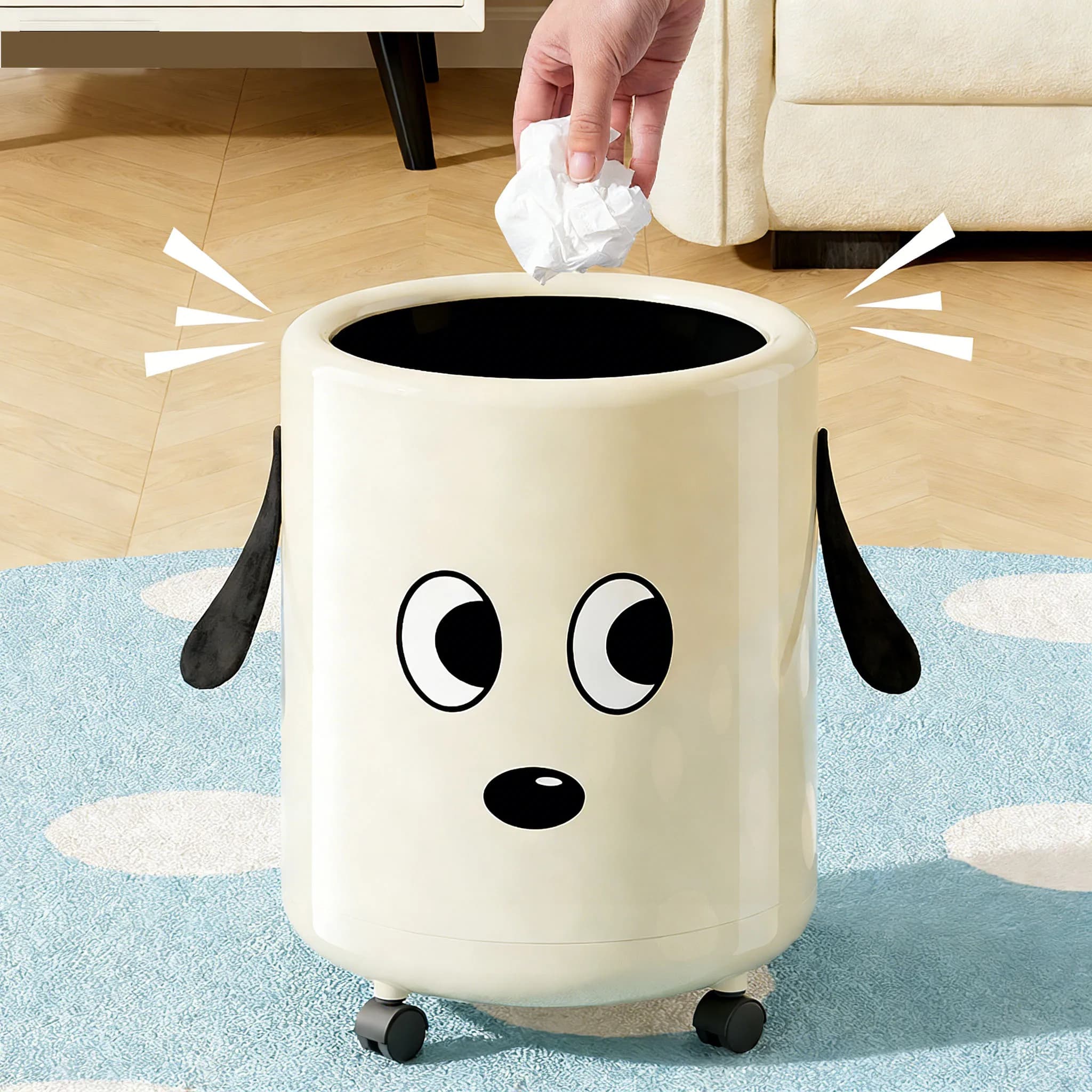 Un cestino per rifiuti con ruote. Presenta un simpatico design di cane in stile cartone animato. Pratico e funzionale come complemento d'arredo.