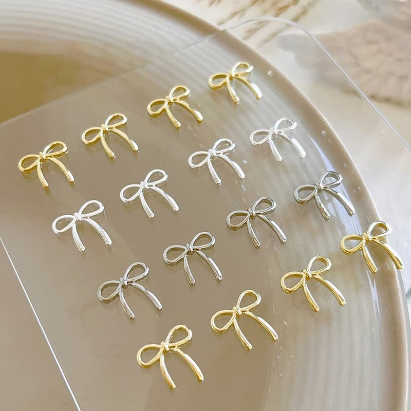 10 pezzi fiocco deco nail art fascino 3D argento/oro bowknot nastro parti di decorazioni per unghie accessori per manicure di lusso fai da te