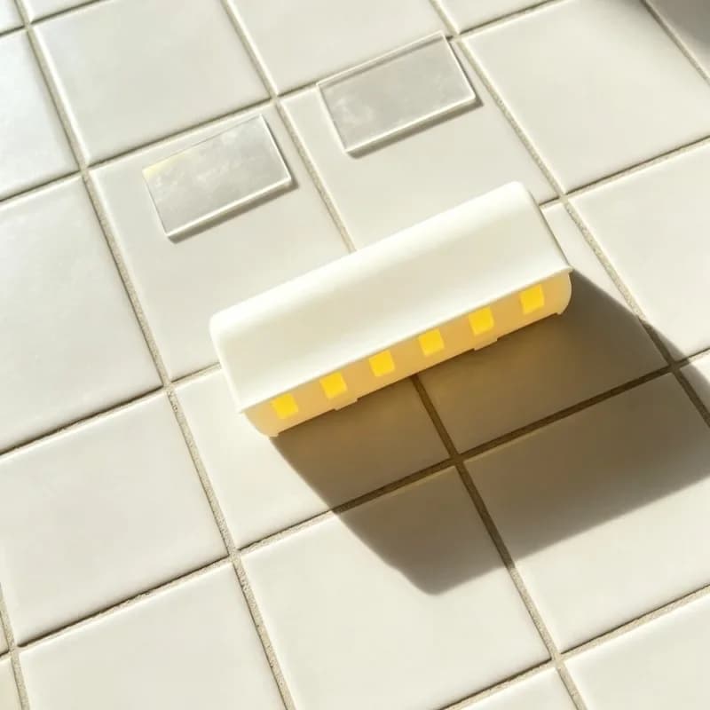 This is a single toothbrush holder that holds up to 6 toothbrushes with a cover and self-adhesive back for easy wall mounting. Highly recommended for toothbrush finishing in bathrooms and shower areas.