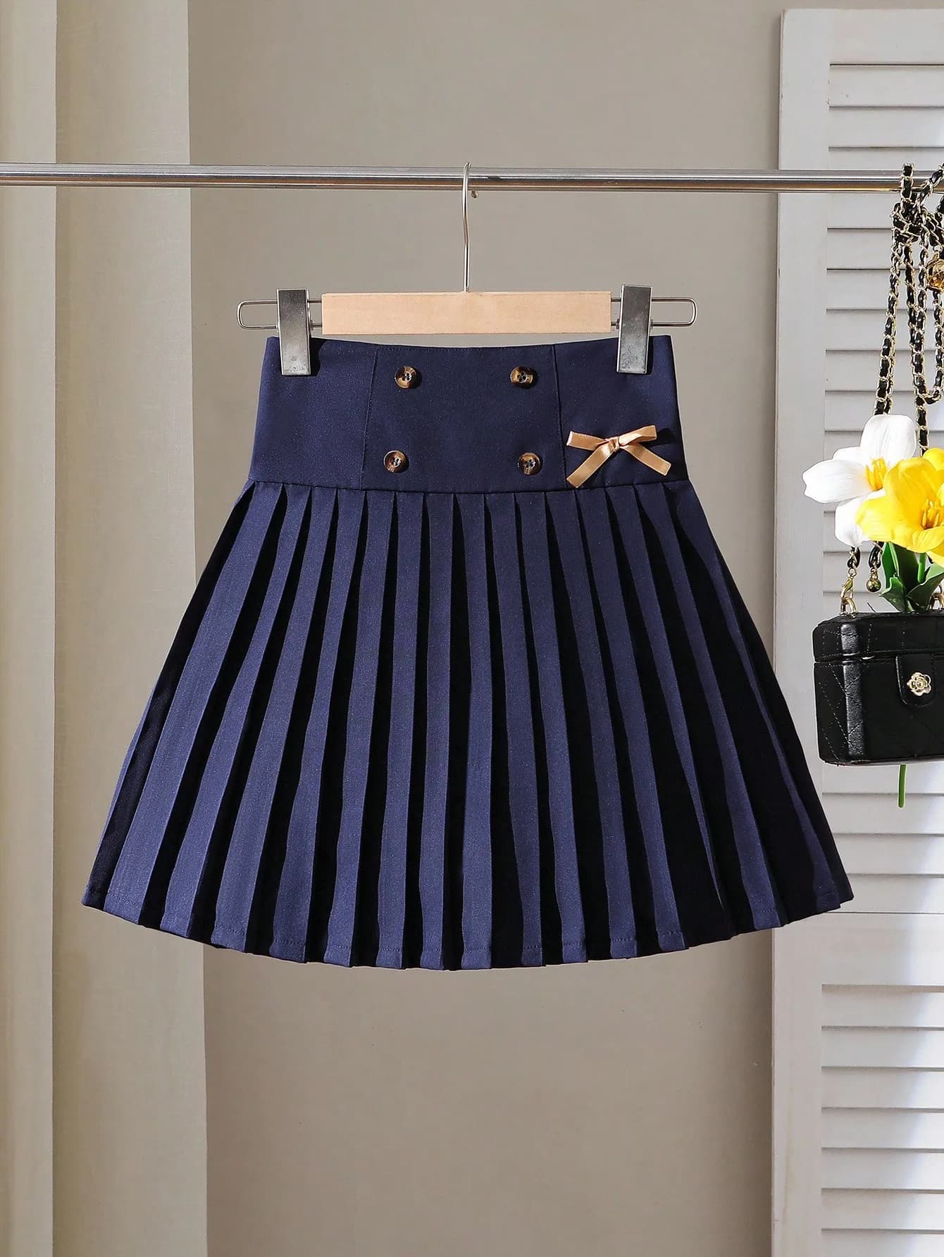 Minigonna a pieghe blu navy con dettaglio fiocco e doppi bottoni