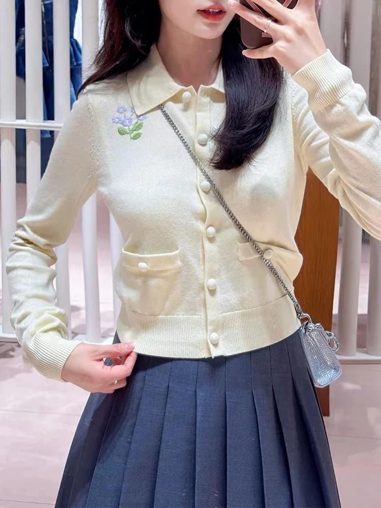 Women's floral-embroidered knit cardigan—a new pale yellow, cropped, long-sleeved sweater with a collar for Autumn 2026.