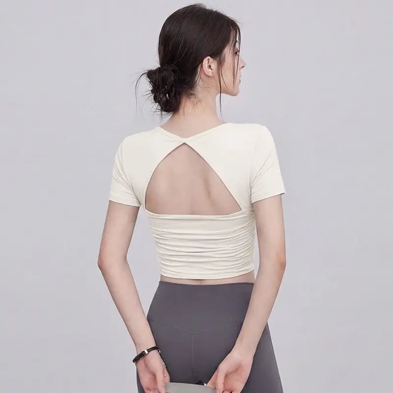 Top Women's Sports Cort with Net Inserts, Short Sleeves, Modeling, for Fitness, Yoga and Professional Pilates Training