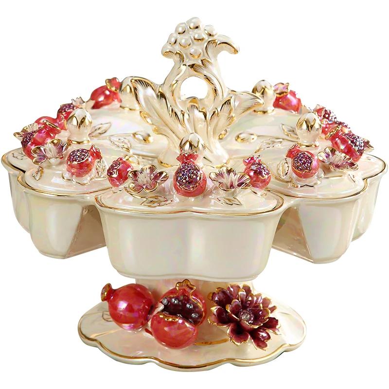 Piatto di frutta europeo in ceramica di fascia alta di lusso creativo rotante piatto di frutta secca griglia con coperchio soggiorno domestico