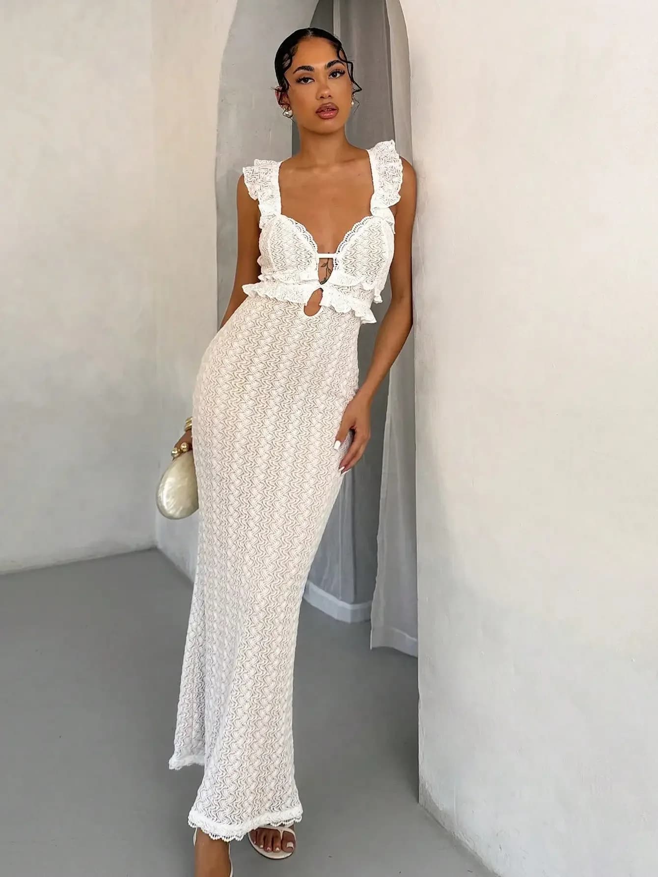 Abito lungo bianco in pizzo all'uncinetto con spalle scoperte, volant e dettagli cut-out
