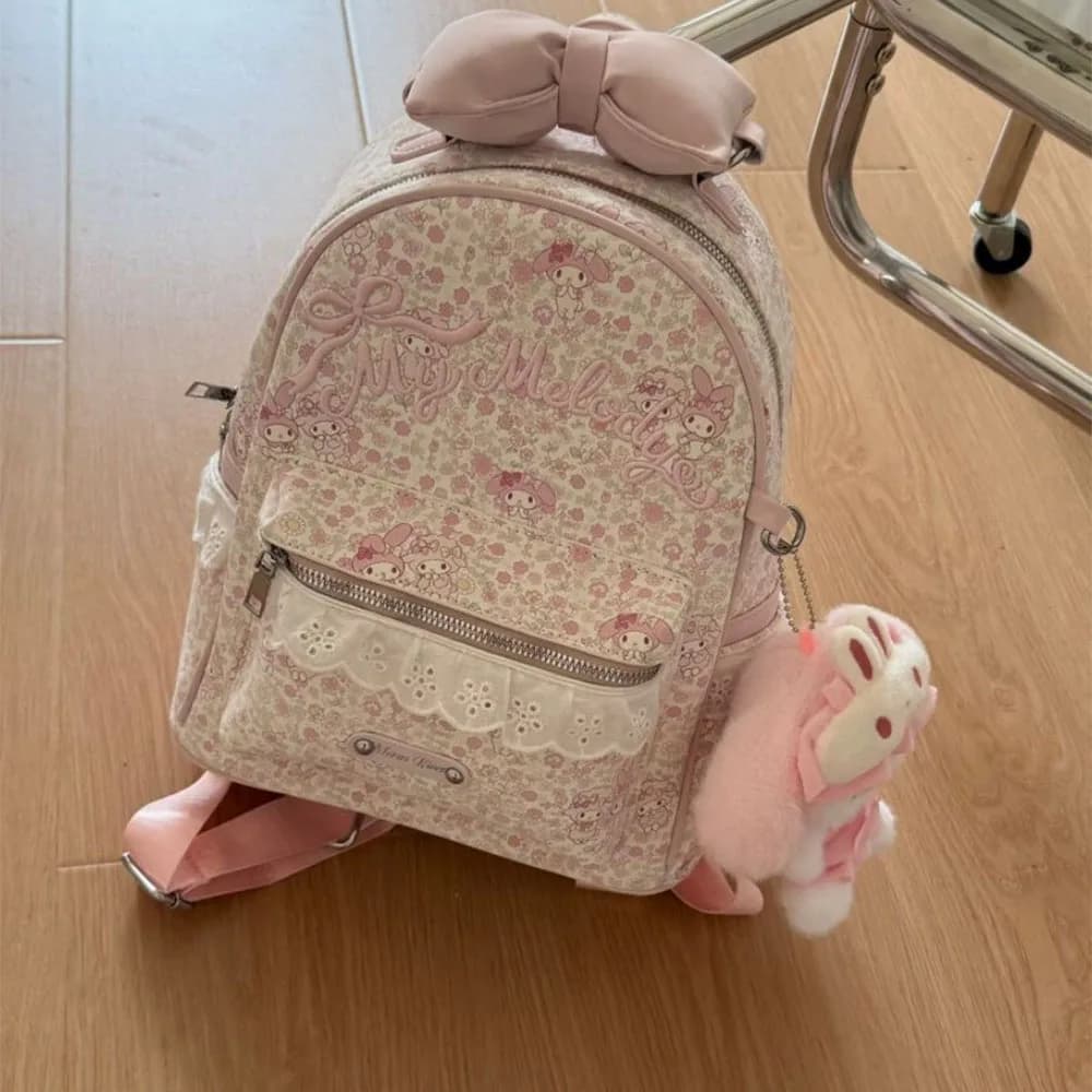 Cute Pink My Melody All-Over Floral Print Mini Backpack Kawaii Cartoon Bow Top Casual Daypack with Plush Charm Small School Bag