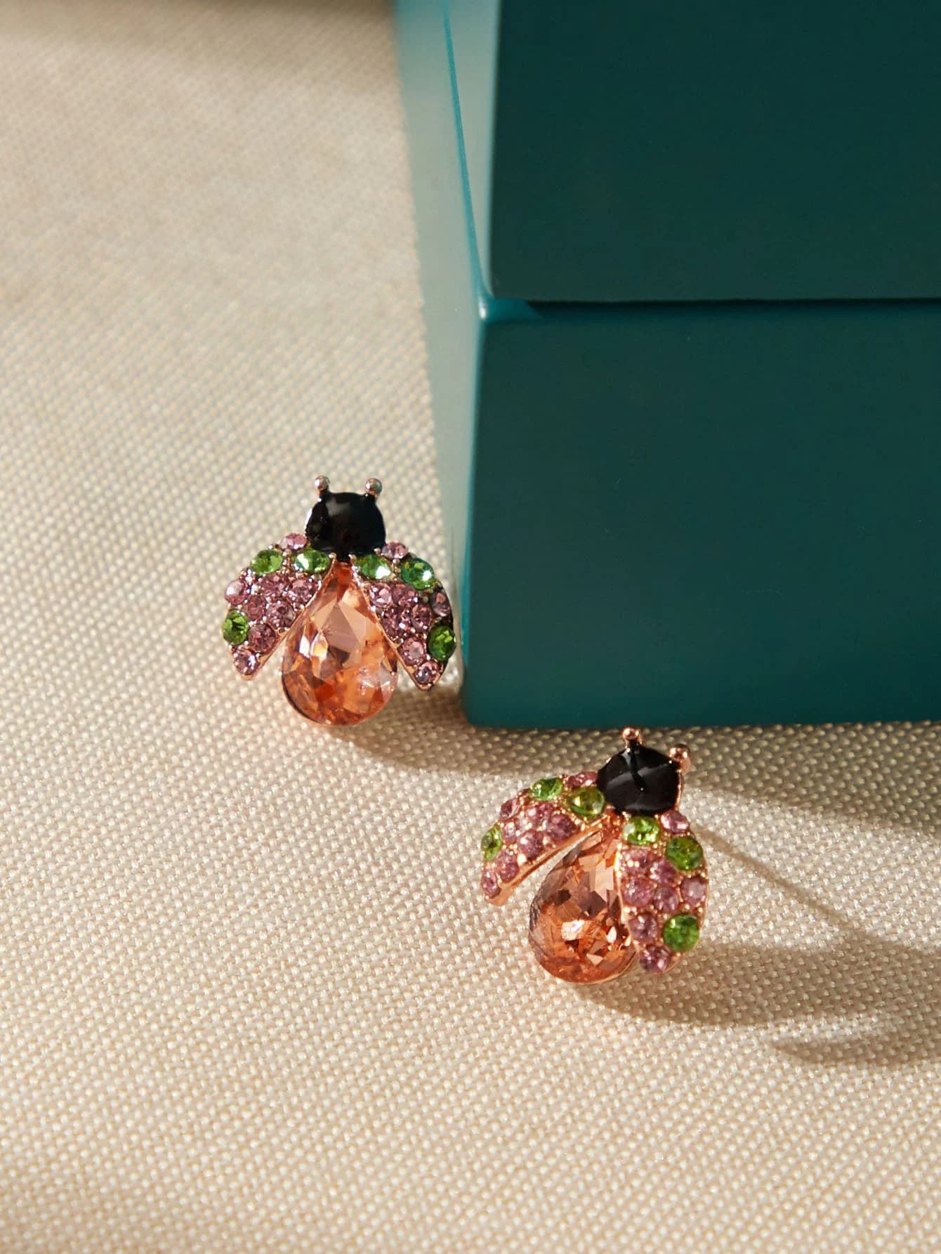 Earrings with rhinestones in the shape of scarab and pink, green and amber crystals