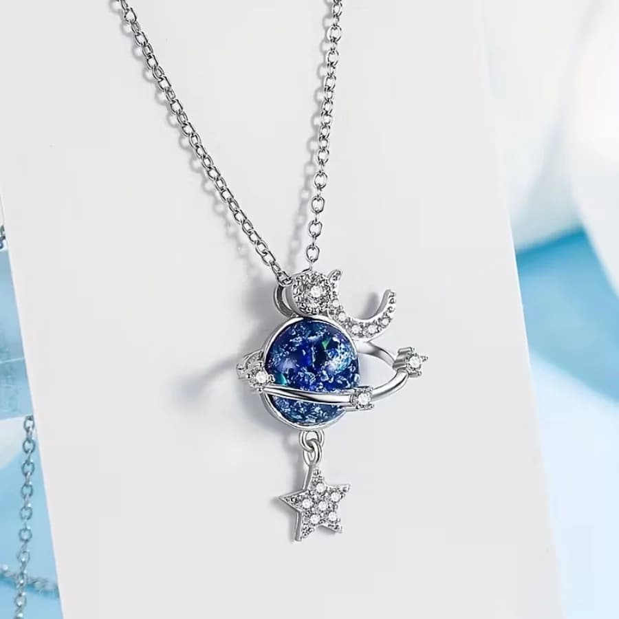 A dreamy cosmic planet necklace with a star and moon design, zircon studded collarbone chain