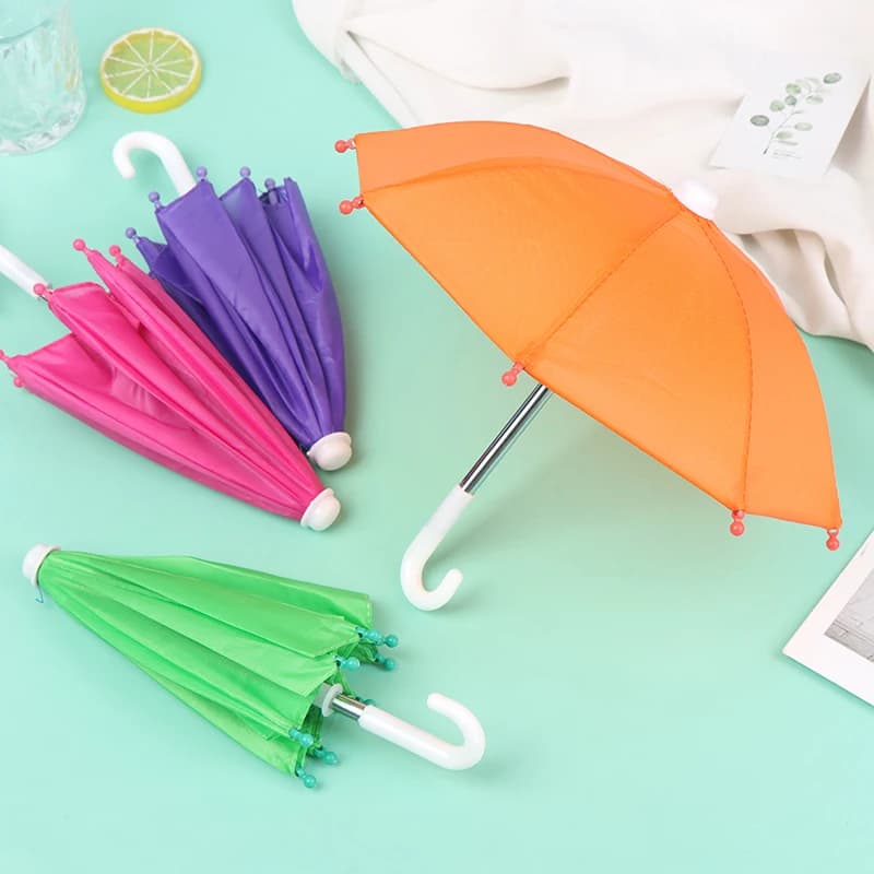 Gli ombrelli colorati della bambola di 22CM giocano l'attrezzatura antipioggia per gli accessori delle ragazze della bambola da 18 pollici