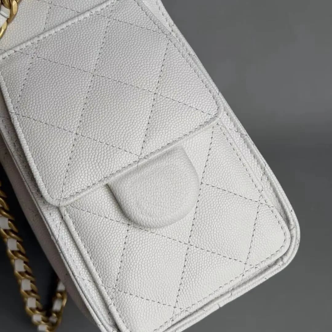 Off-white caviar leather quilted drawstring bucket bag, flap with side pocket design, interwoven gold chain strap, medium capacity, an elegant crossbody, shoulder, and hand-carry bag for women.