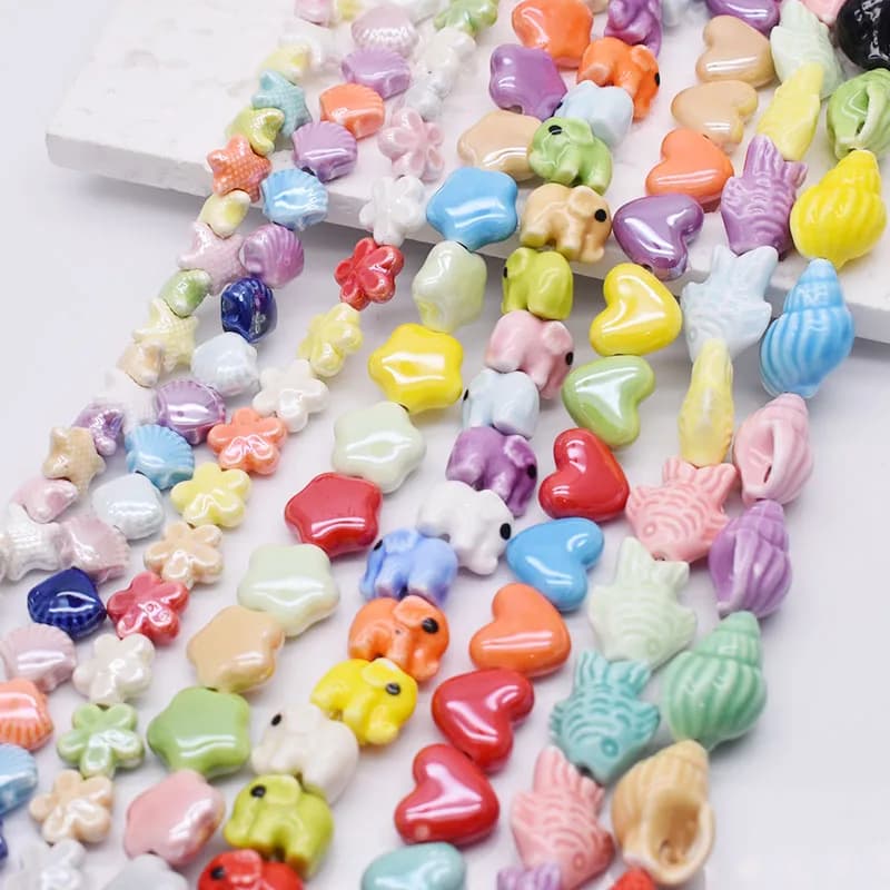 Misto 20 pz/lotto perline di ceramica stella di pesce stella marina fiori elefanti cuore perline distanziatrici allentate per gioielli che fanno braccialetto fai da te