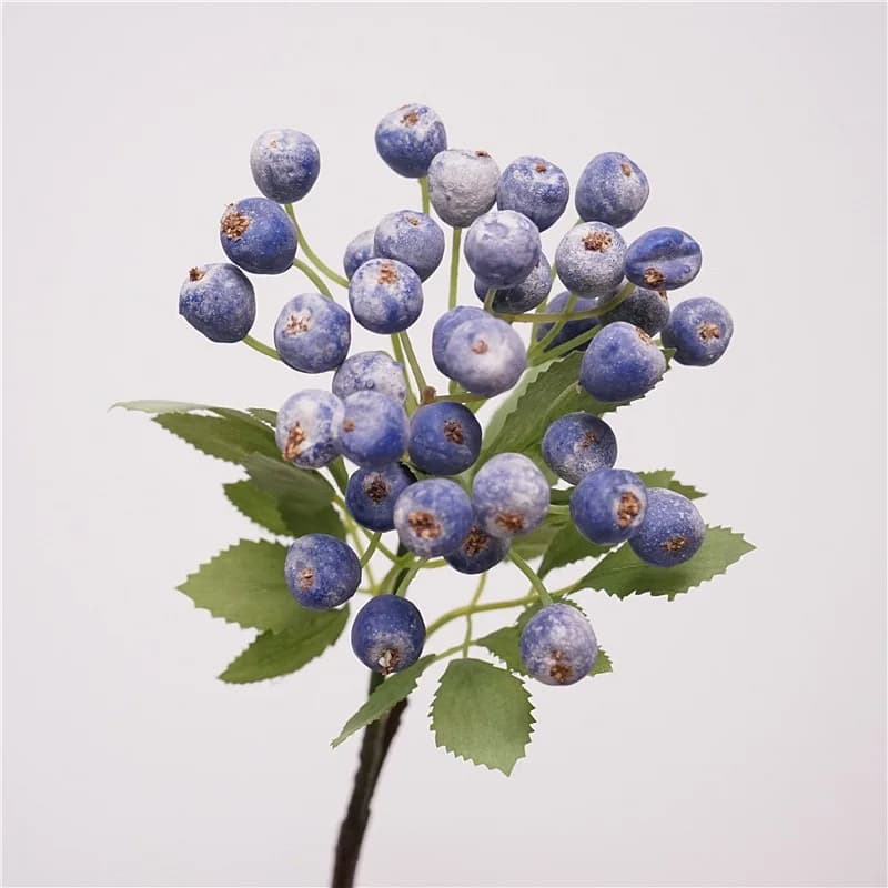 Artificial cranberries sprinkled in pot: realistic stems of fake berries with green leaves, wedding bouquets and Christmas tree decorations
