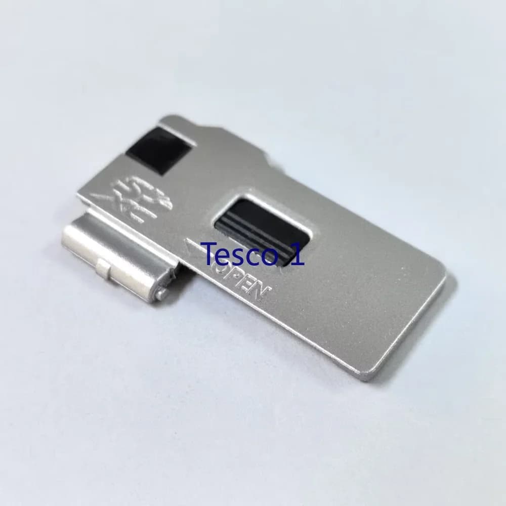 Nuovo (Argento) per Olympus EM10II EM10III EM10 Mark II EM10 Mark III Durevole coperchio dello sportello della batteria Tappo del coperchio Parte della fotocamera digitale