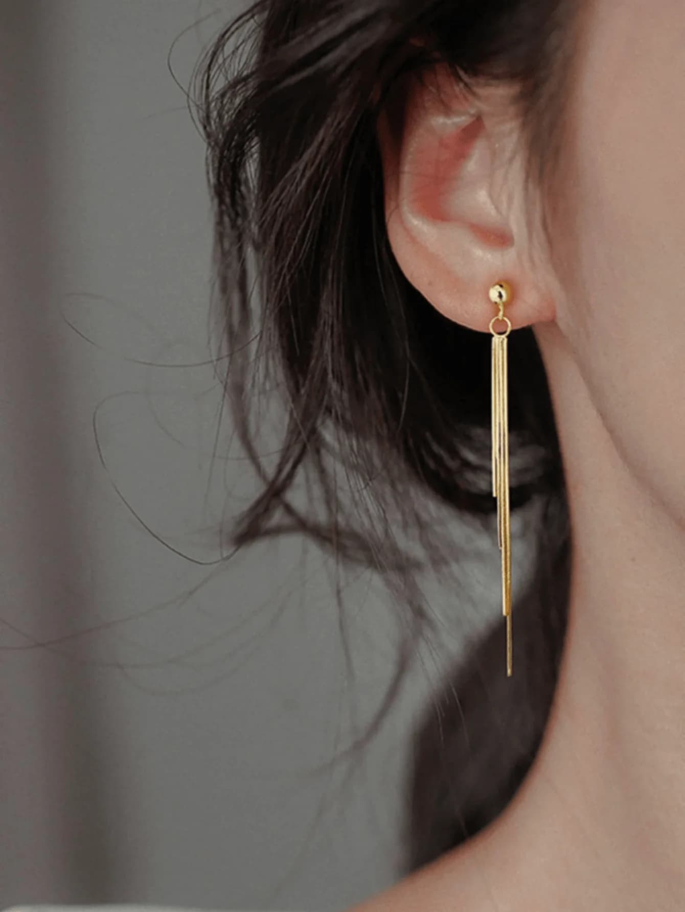 Fashion gold-tone long tassel earrings with delicate chain dangle design for women’s everyday wear