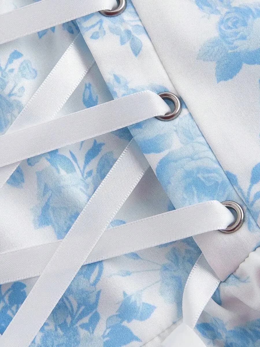 Mini abito con stampa floreale blu e bianca, con finiture in pizzo, spalline sottili e schiena incrociata, per outfit primaverili da donna