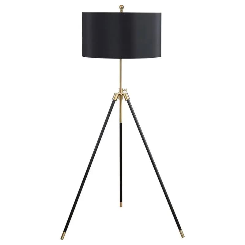 Lampada da terra treppiede nera e dorata con paralume a tamburo: illuminazione moderna ed elegante per la decorazione domestica, il soggiorno o la camera da letto