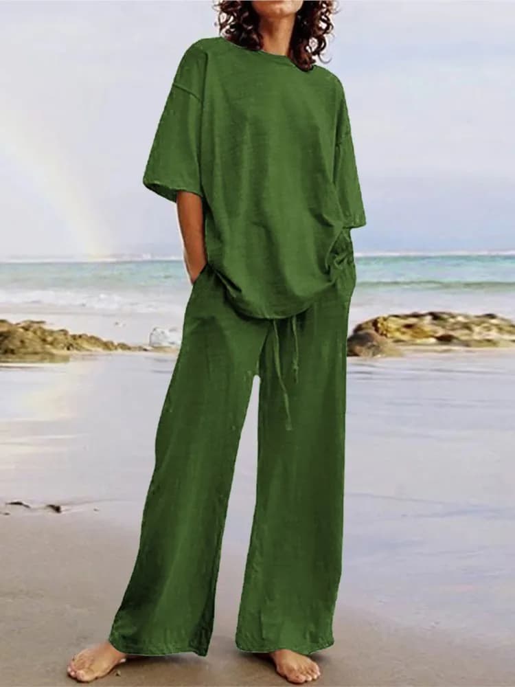 Moda estate 2024, completo casual da donna a due pezzi con cintura e tasche, top a mezza manica con scollo rotondo e pantaloni a gamba larga con cinturino.