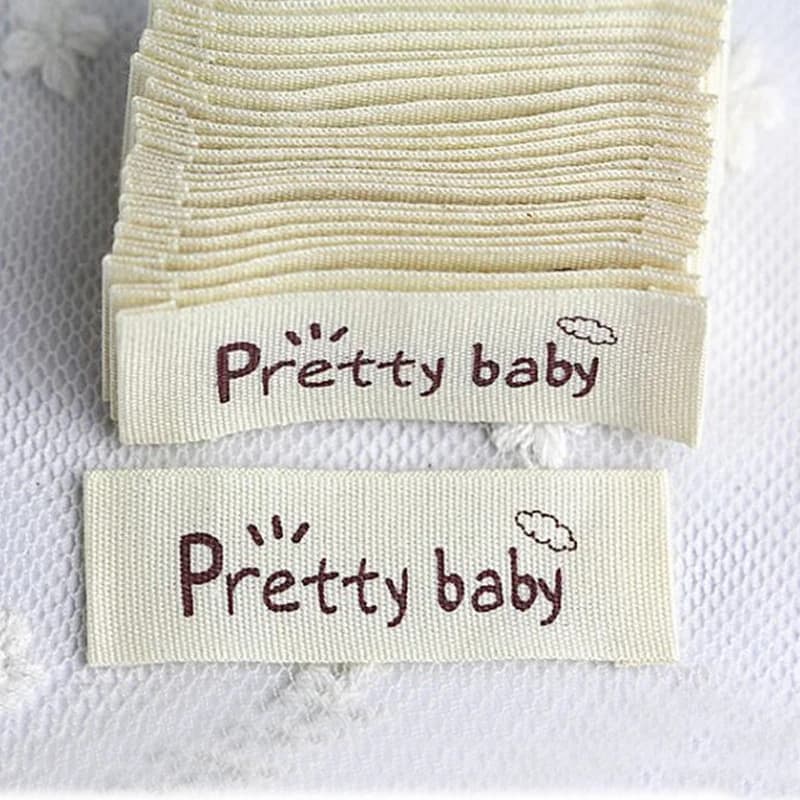 Etichette per indumenti in cotone bianco sporco naturale con stampa a un colore di Design personalizzato etichette per abbigliamento etichette in cotone serigrafate