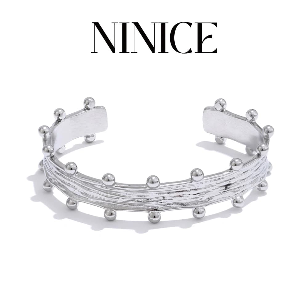 NiNice Bracciale in metallo aperto con perline a strisce lucide in acciaio inossidabile 316L Gioielli popolari e attraenti 2025