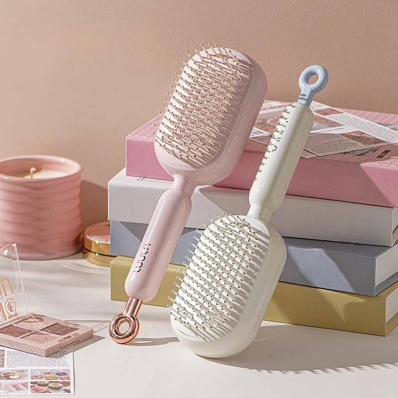 Spazzola per capelli retrattile autopulente con pettine districante antistatico facile da tirare per tutti i tipi di capelli, strumento per lo styling ergonomico