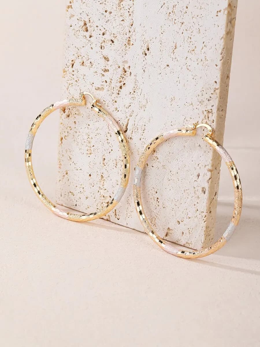 Textured metal hoop earrings with elegant circular design and subtle surface detail for versatile styling