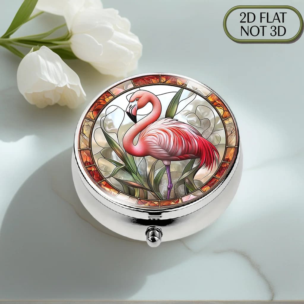 A flat, portable, round metal pill box, adorned with a vibrant stained glass flamingo pattern, is a stylish and convenient way to store your supplements and medication. It is the perfect choice for organizing vitamins, keeping small items safe, or as a thoughtful gift, thanks to its flat design
