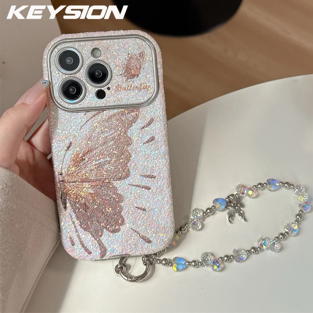 KEYSION Custodia per telefono a farfalla da donna per iPhone 14 15 16 17 Pro Max Cover antiurto con bordi arrotondati con catena per bracciale con perline