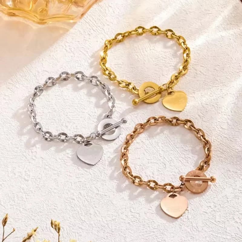 Bracciale in acciaio al titanio di moda con ciondolo a cuore Bracciale per coppia con fibbia OT a doppio cuore per commercio all'ingrosso di gioielli unisex da donna