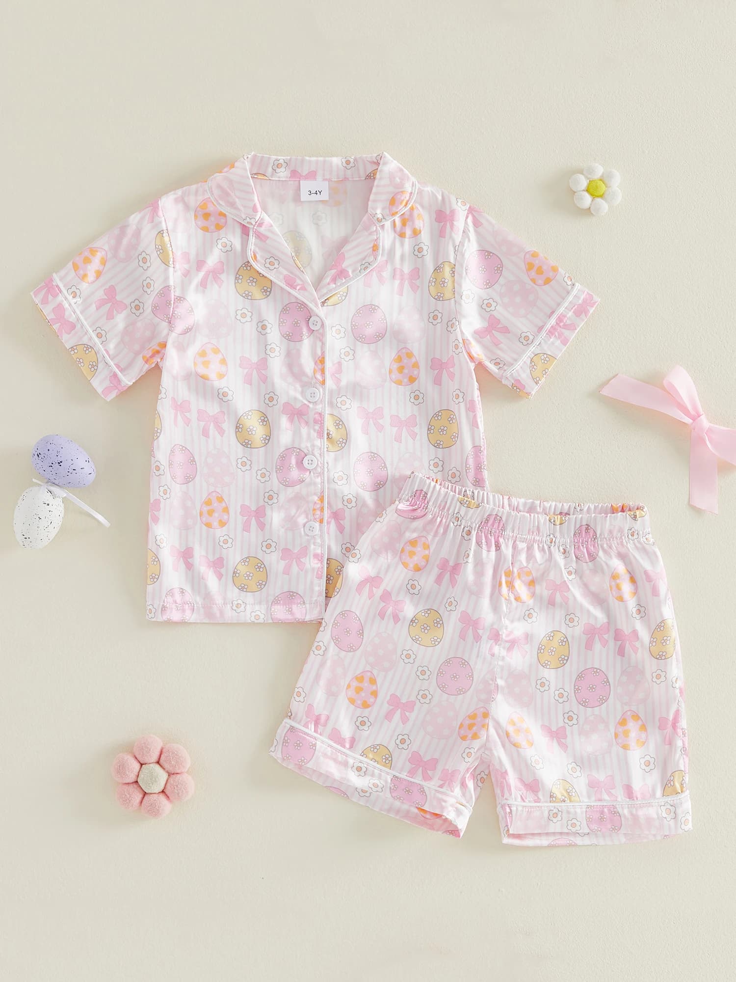 Cute paschal set for children with bunny print, short sleeved top with buttons and shorts with elastic waist, complete with night in 2 pieces for
