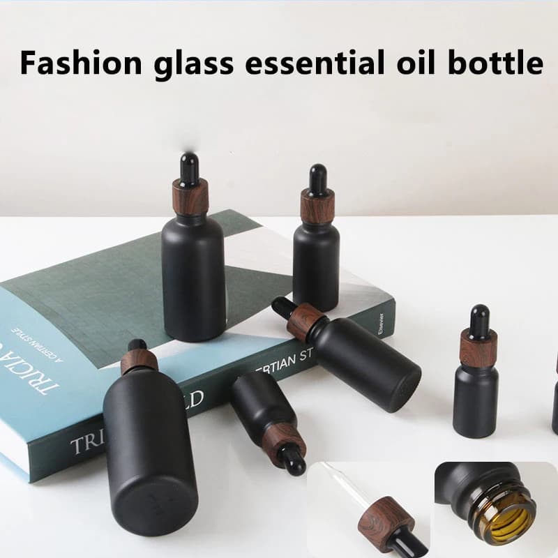Bottiglie contagocce in vetro nero smerigliato Bottiglia vuota con pipetta gocciolante in vetro brillante Coperchio in plastica per siero di olio essenziale di profumo