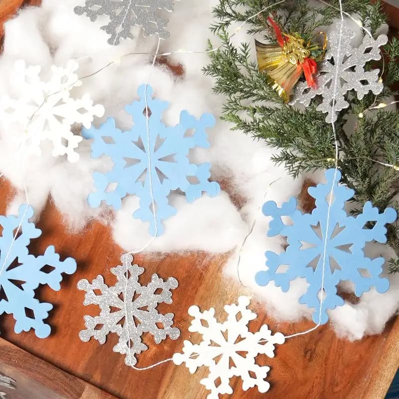 Paper flags with handcrafted snowflakes: Christmas decorations in silver and gray for parties and celebrations