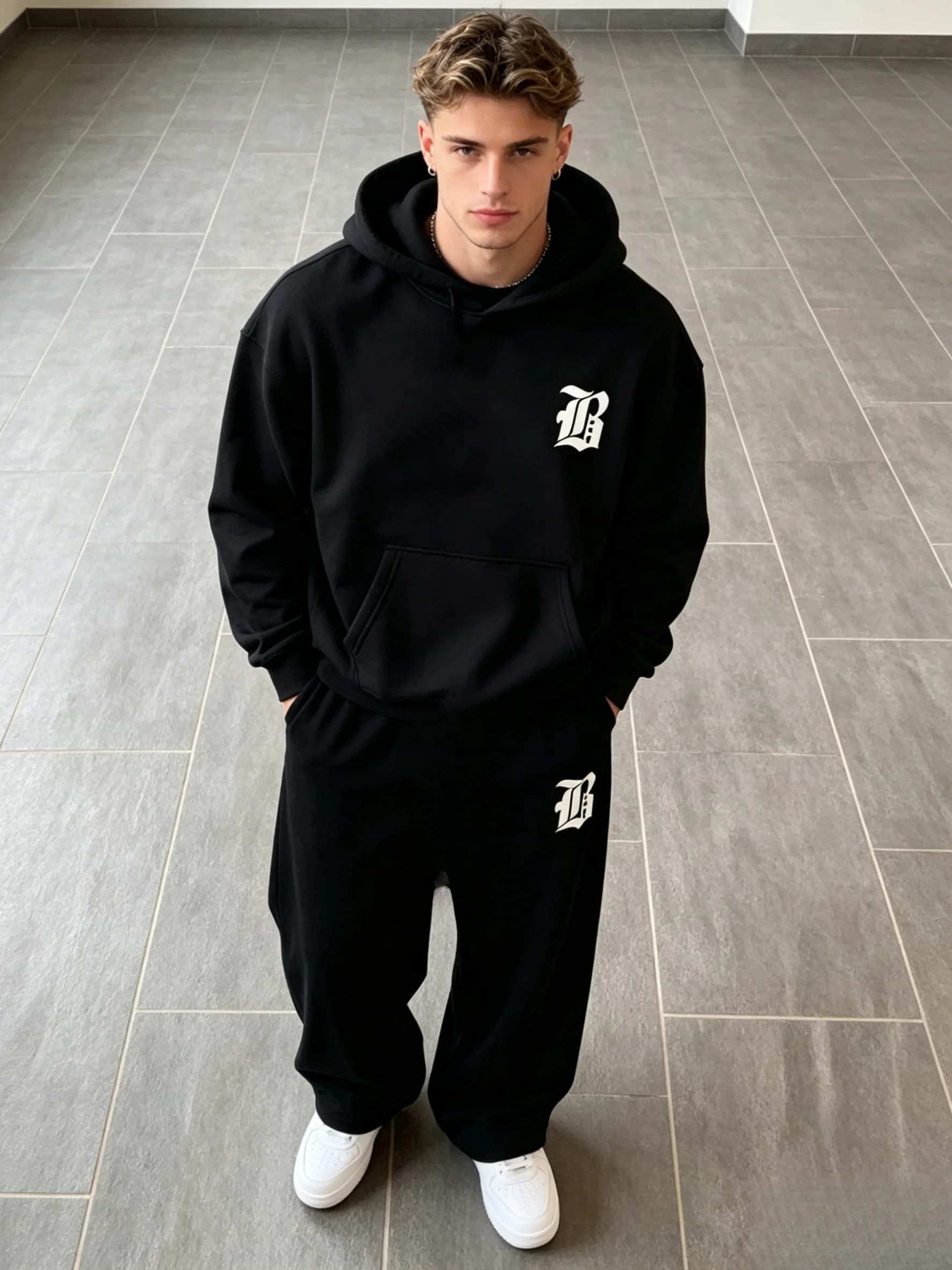 The autumn-winter men's hoodie set includes a hooded hoodie with classic pattern prints and versatile sports pants.