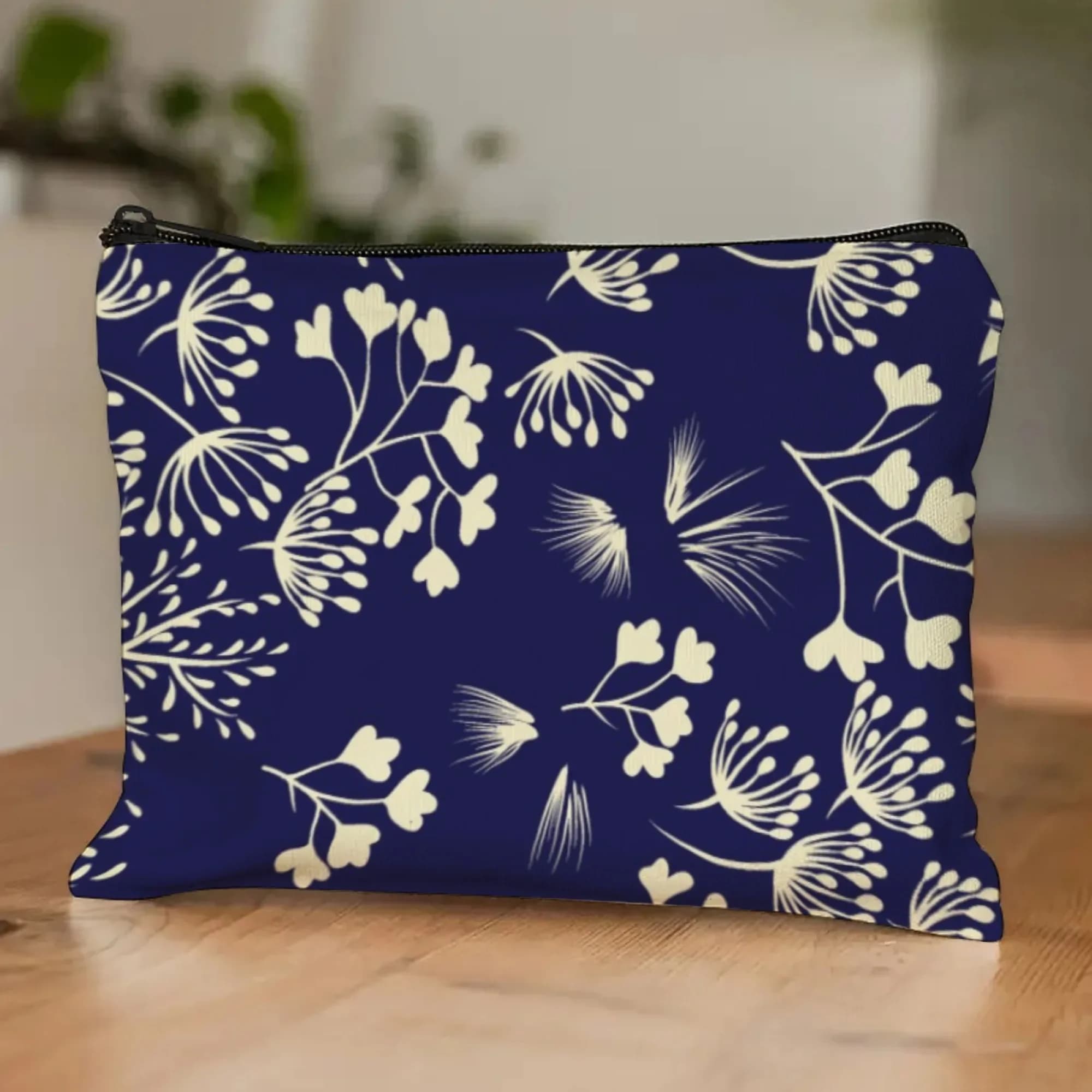 Navy blue rural botanical cosmetic bag, models of plants in cream, flowers, branches, seeds, makeup case for nature lovers