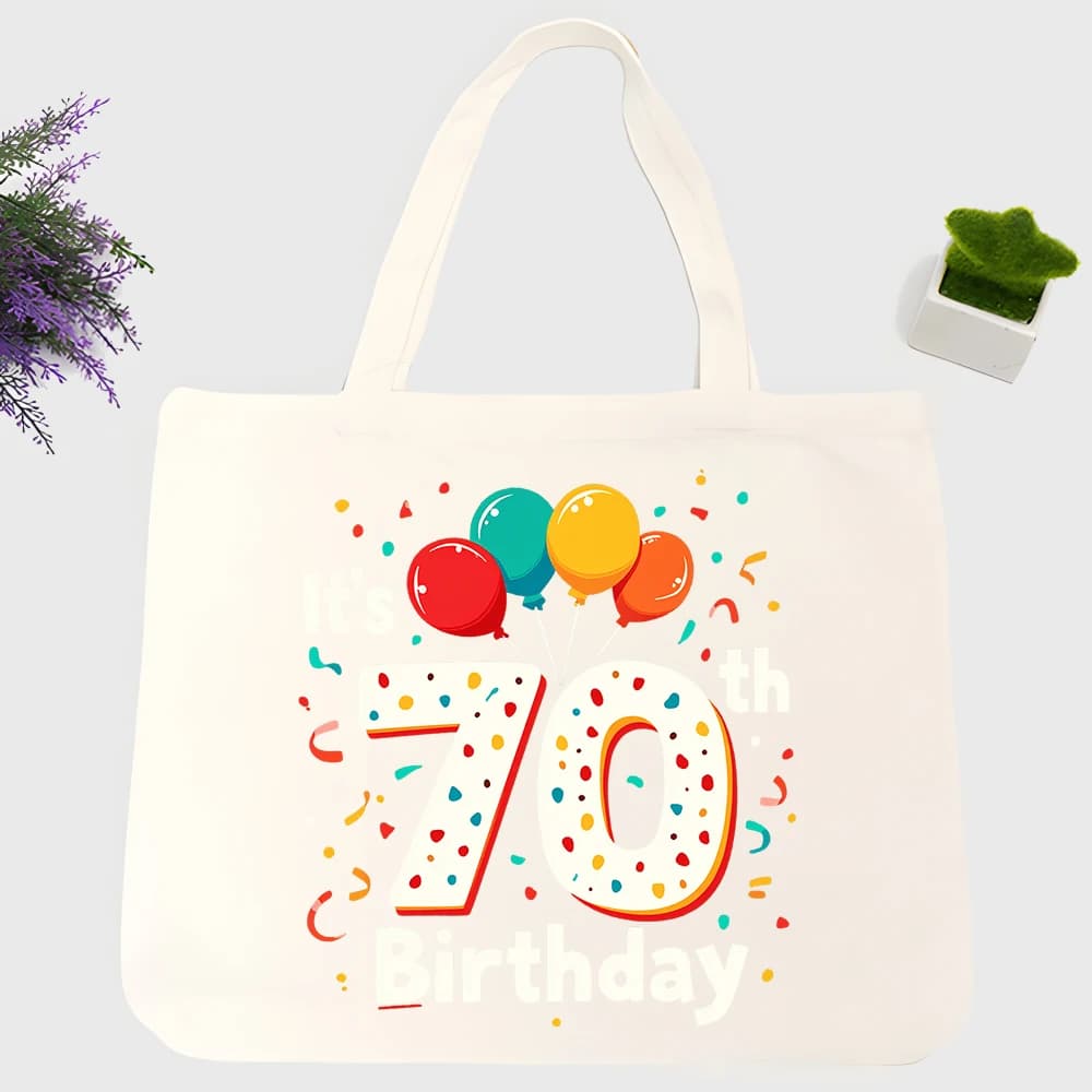 Men's 70th birthday graphic canvas tote bag with colorful balloons and confetti, perfect for casual birthday celebrations and