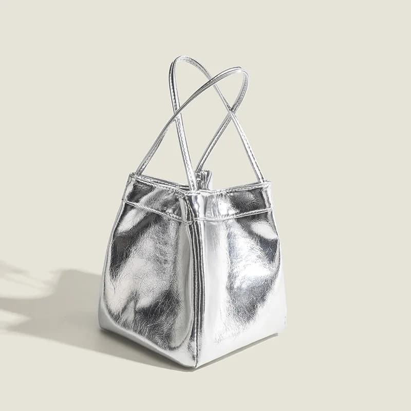 Borsa a secchiello in argento per donna 2025Nuova borsa per il pranzo alla moda e semplice Borsa piccola a mano con texture in stile occidentale di nicchia