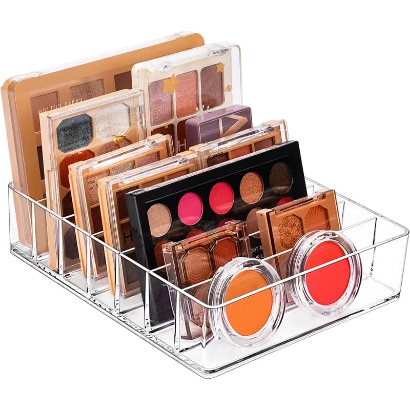 7-compartment organizer for eyeshadow palettes & lipsticks, holds lipsticks, highlighters. Displays skincare & cosmetics on bathroom vanity tops; stores small parts, charging cables & office supplies