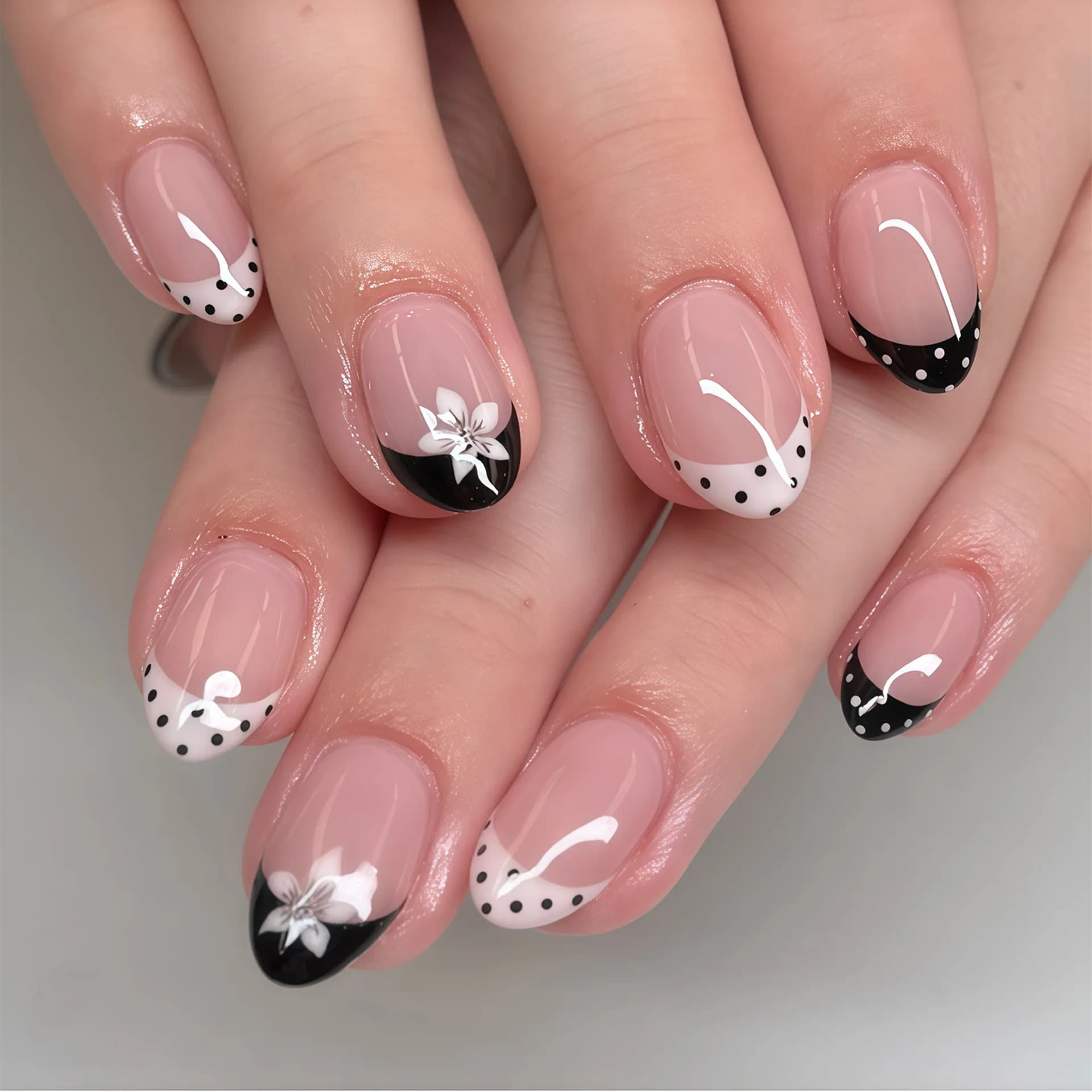 24 handmade short square nails. Sheer nude base with black & white polka dot French, decorated with small flowers. Reusable, swe