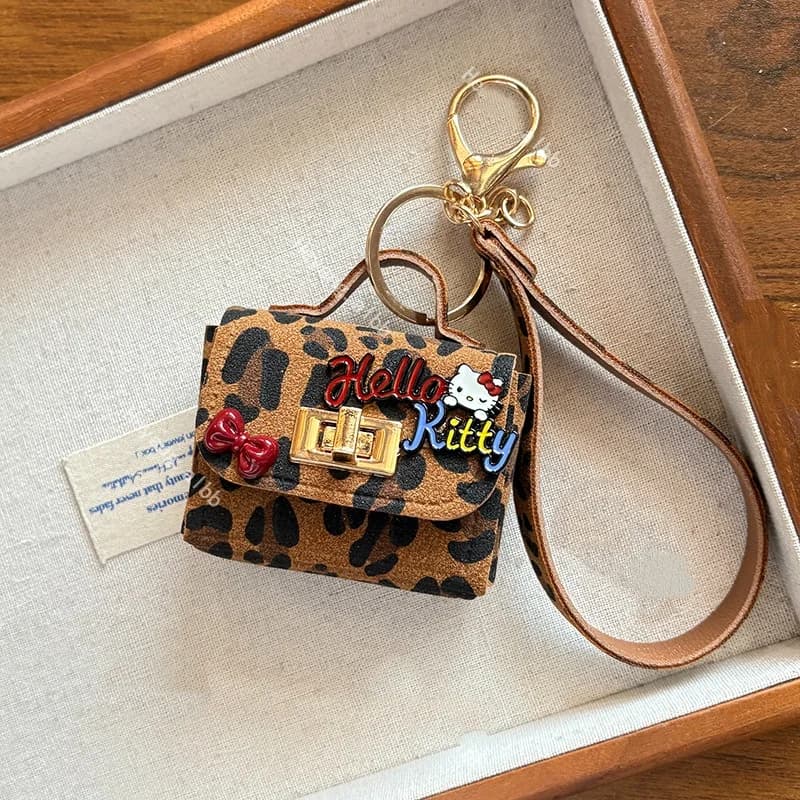 Sanrio Hello Kitty Retro Leopard Print Cat Borsa per cuffie Ciondolo Tendenza moda Portachiavi Temperamento decorativo Pacchetto creativo