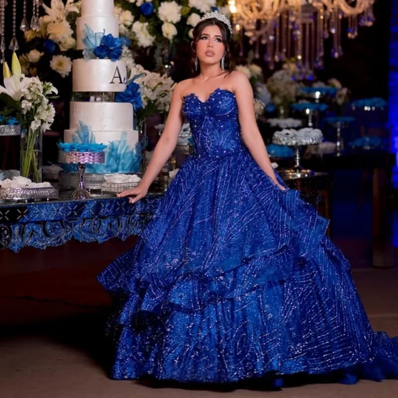 Abito Quinceanera blu royal lucido con spalle scoperte Stratificazione di pizzo Decalcomania Coda lunga Fiocco Abiti da 15 Quinceanera Personalizza