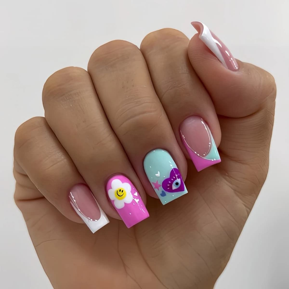 A complete set of 24 short square fake nails, made with French color block design with colorful smiling faces and European and American style, including 1 gelatinous glue and 1 buffer, perfect for parties, dances and daily clothing, removable and reusable.