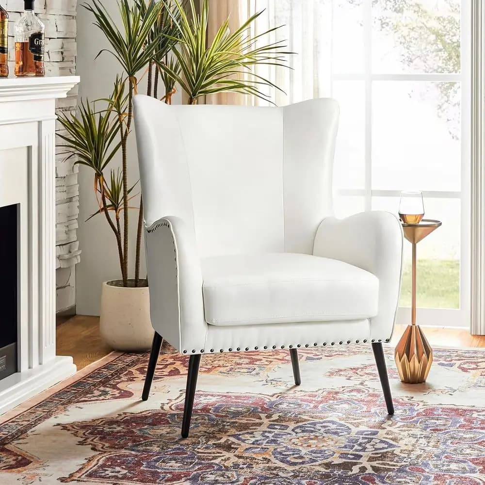 Poltrona con accenti in pelle e cuscino rimovibile, comoda poltrona imbottita con gambe in metallo nero e finiture a chiodi, sedia da toeletta Wingback
