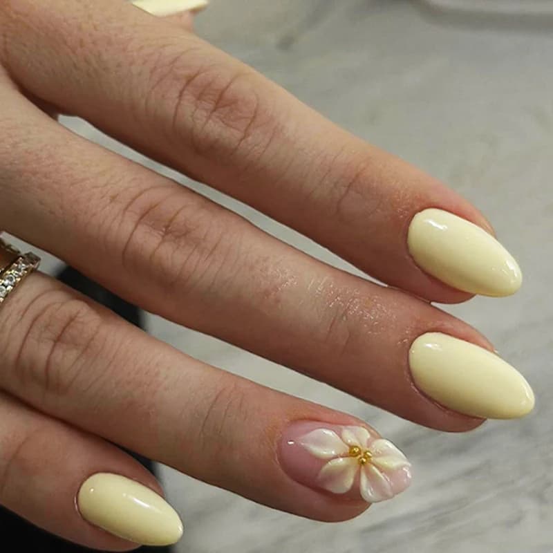 24 pieces of yellow almond fake nails with french floral decorations, solid color design, pink flowers, fake nail art, removable and wearable nail sets for everyday use.