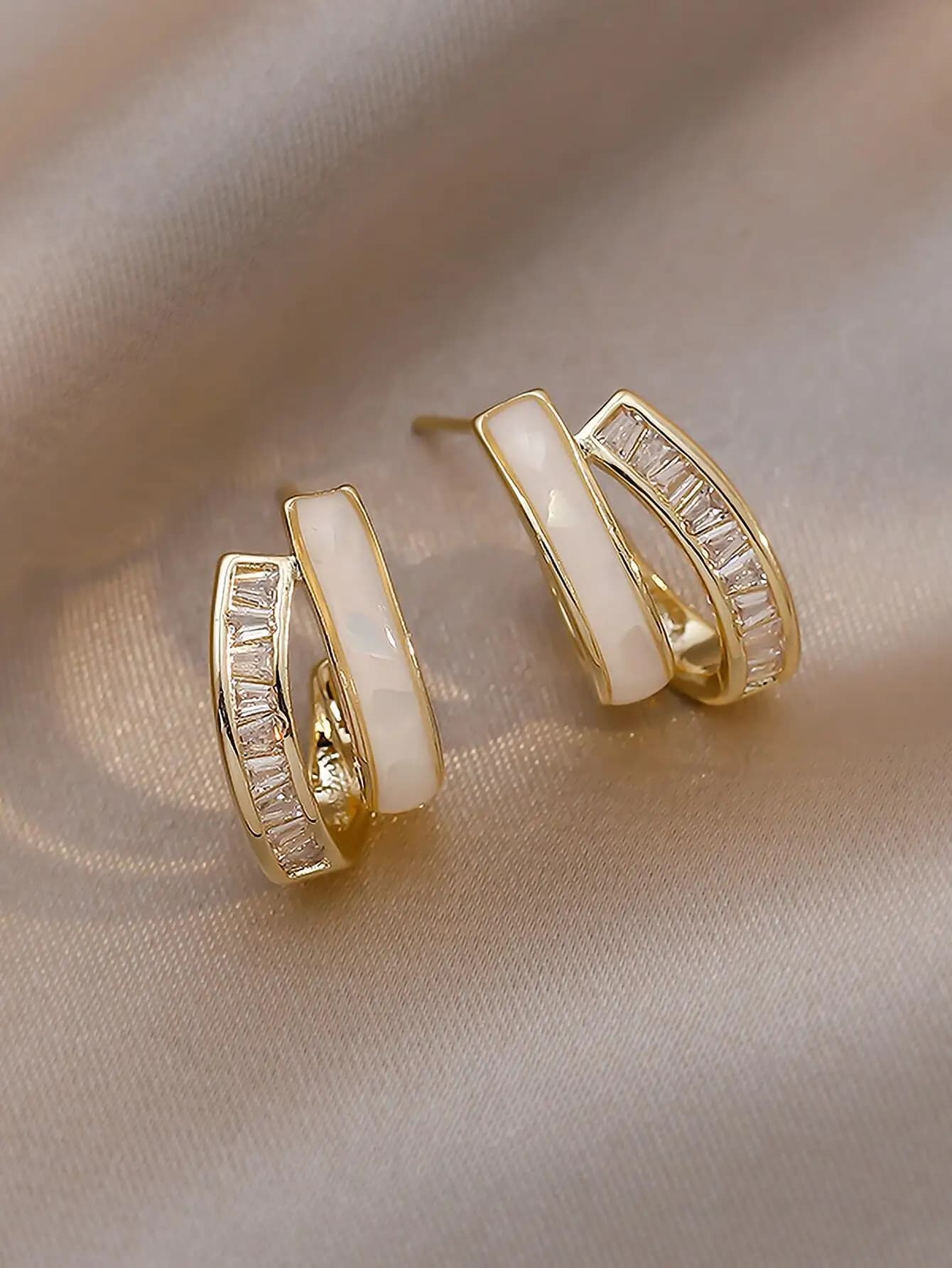 Elegant golden lobe earrings with white opal and cubic zircons with baguette