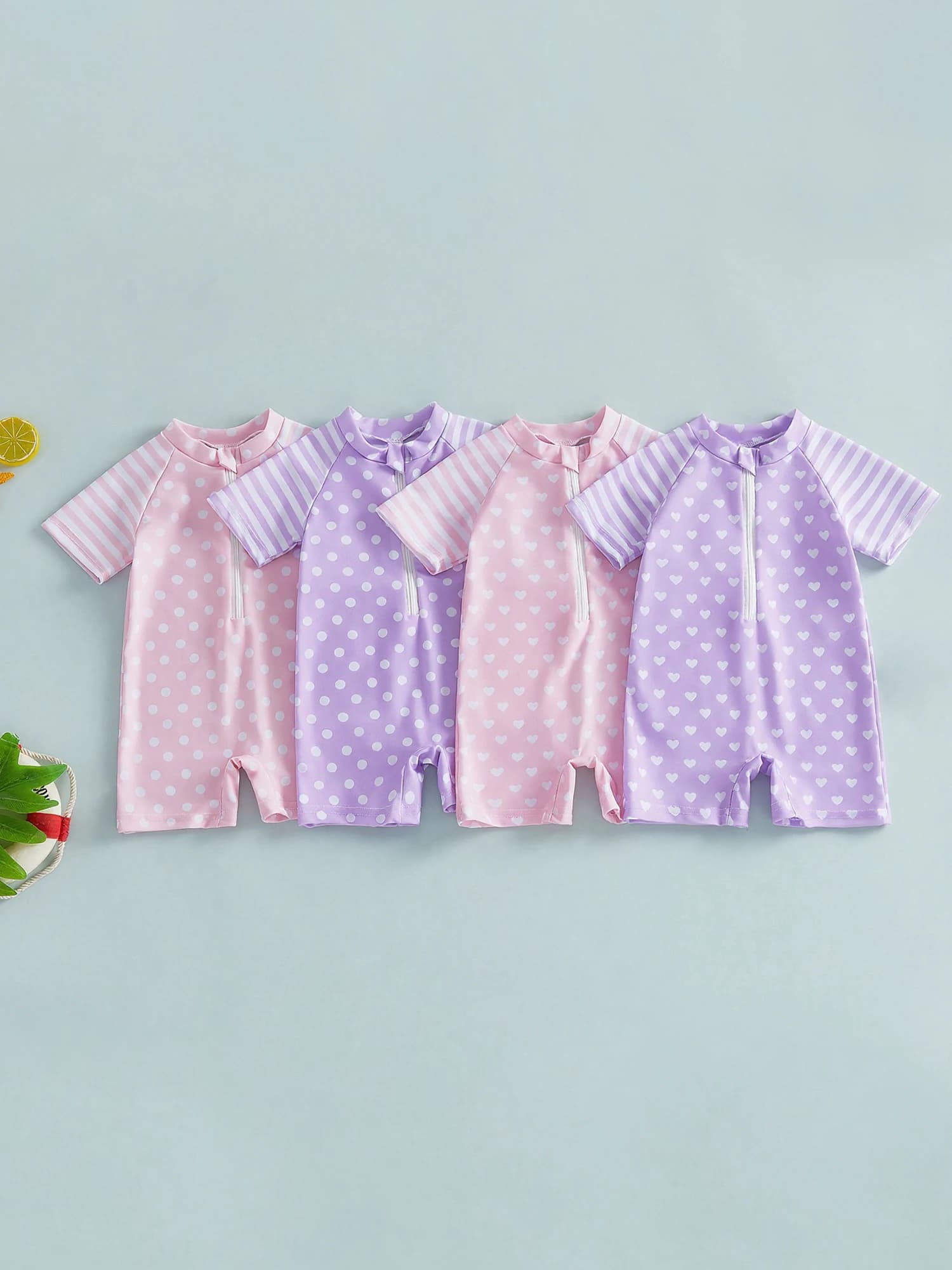 Lovely swimsuit for newborn with short sleeves, crew neck, polka dot print and rows, front zip closure
