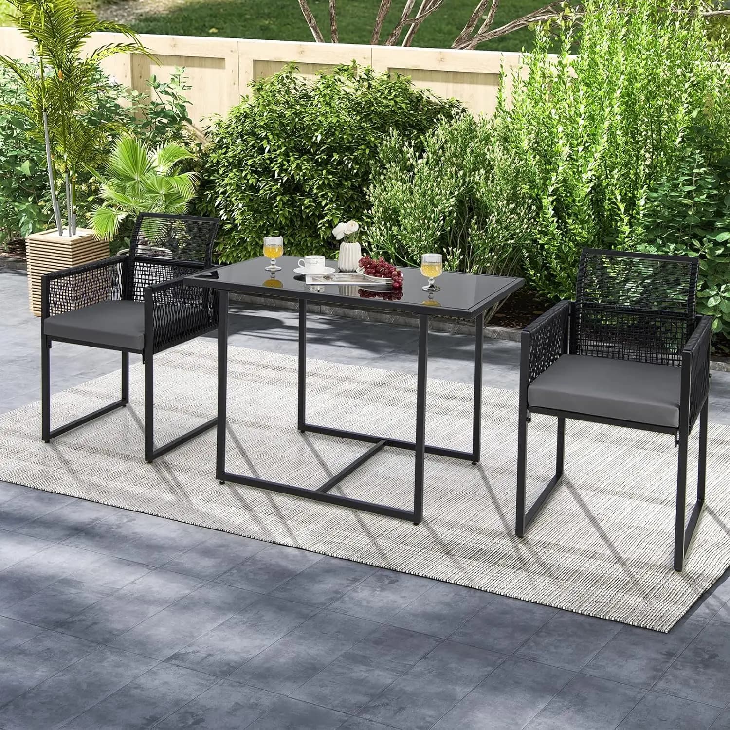 Outdoor dining set in 3 pieces: rattan garden furniture with padded seats and tempered glass top