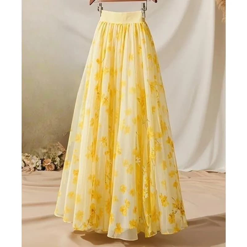 Completo due pezzi da donna con camicia gialla e gonna floreale che nasconde le formature, ideale per primavera e autunno.